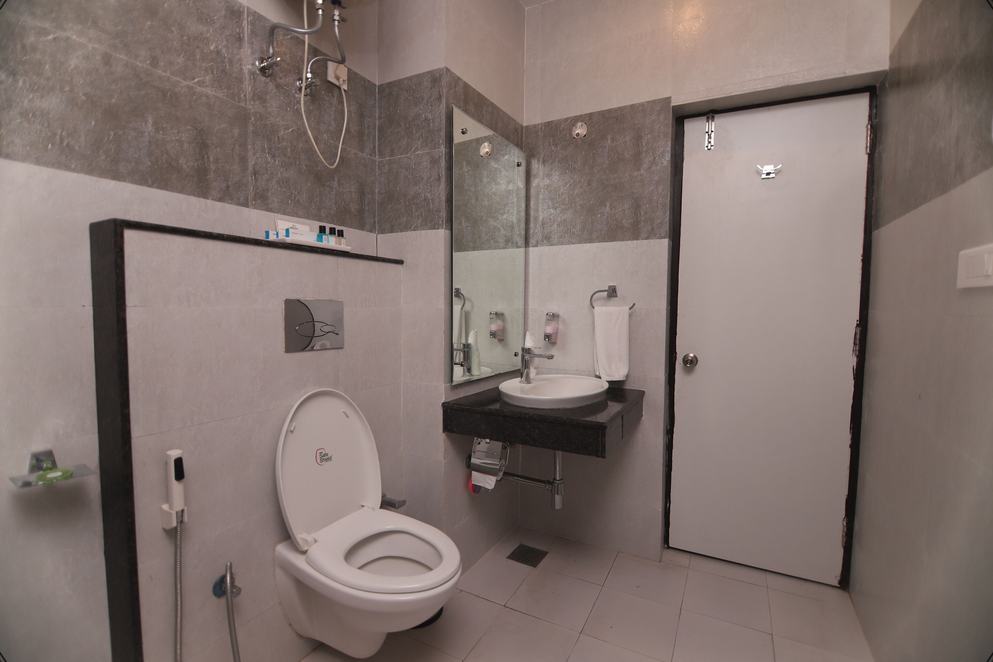 A modern bathroom with a toilet, sink, and shower.