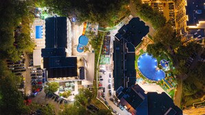 An aerial view of a hotel complex with multiple buildings, parking areas, and a swimming pool. - Prestige Hotel and Aquapark (Golden Sands)