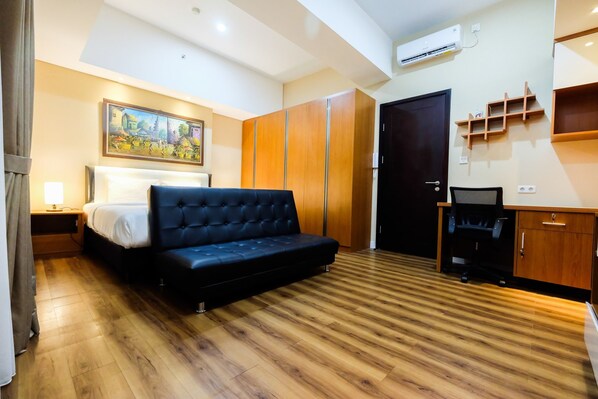 A bedroom with a bed, a sofa, a wardrobe, a desk, and a chair. - Exclusive 1BR Casa De Parco Apartment near AEON Mall (Pagedangan)