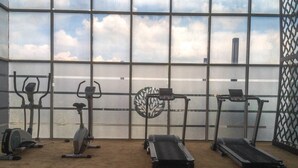A gym with various exercise equipment including treadmills, an elliptical, and a stationary bike.
