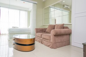 Room | Living area | TV - Spacious 1BR Dago Suites Apartment (Bandung)