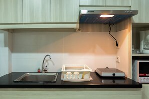 Room | Private kitchenette | Fridge, microwave, stovetop, cookware/dishes/utensils - Studio Room Azalea Suites Apartment (Cikarang)