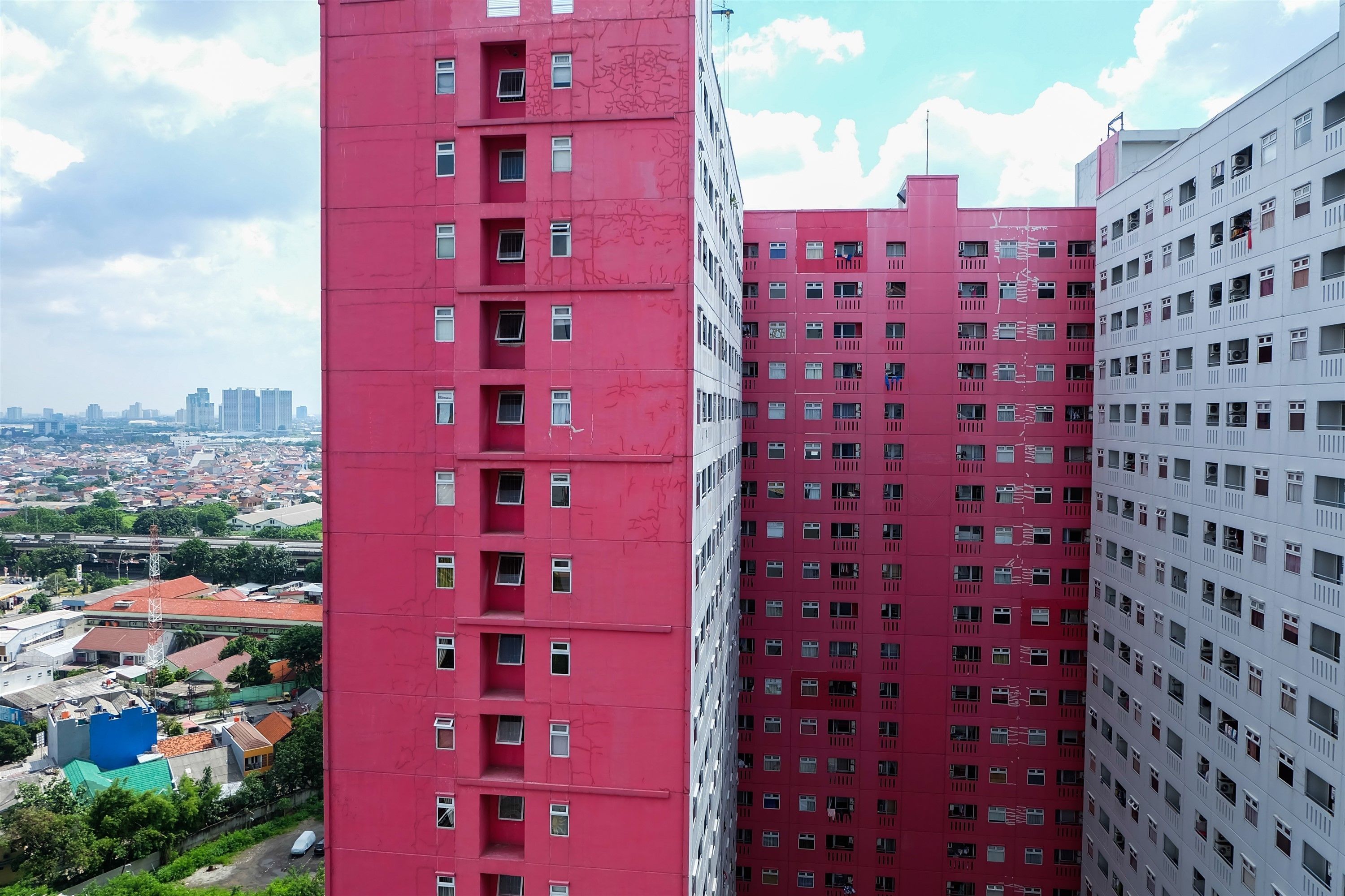 A high-rise building with multiple floors and numerous windows.
