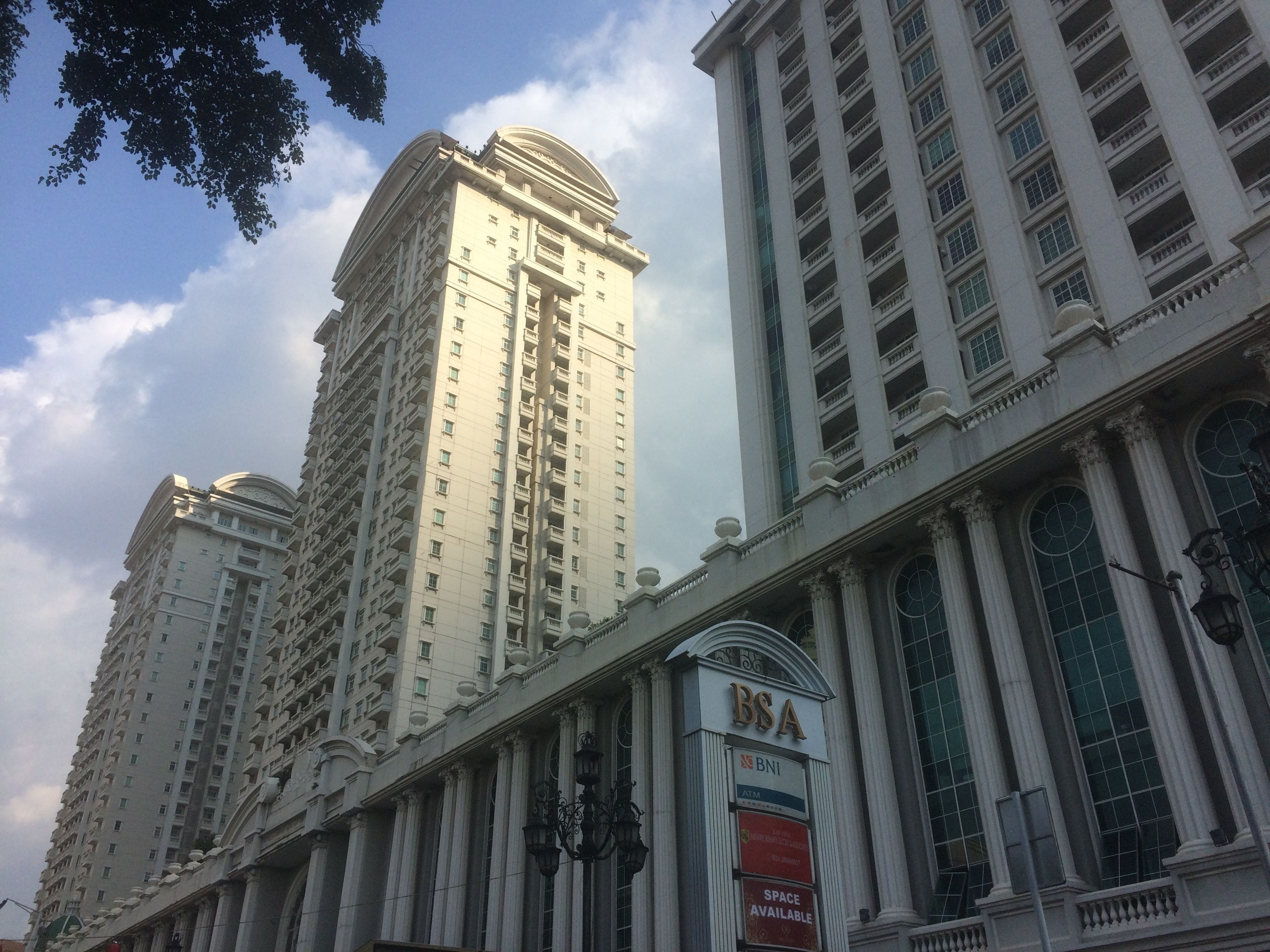 A high-rise building with a classical architectural style, featuring multiple balconies and large windows.