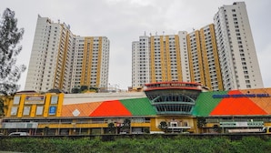 A large commercial building with multiple high-rise apartments and a central atrium. - Minimalist Studio Room Great Western Apartment (Tangerang)