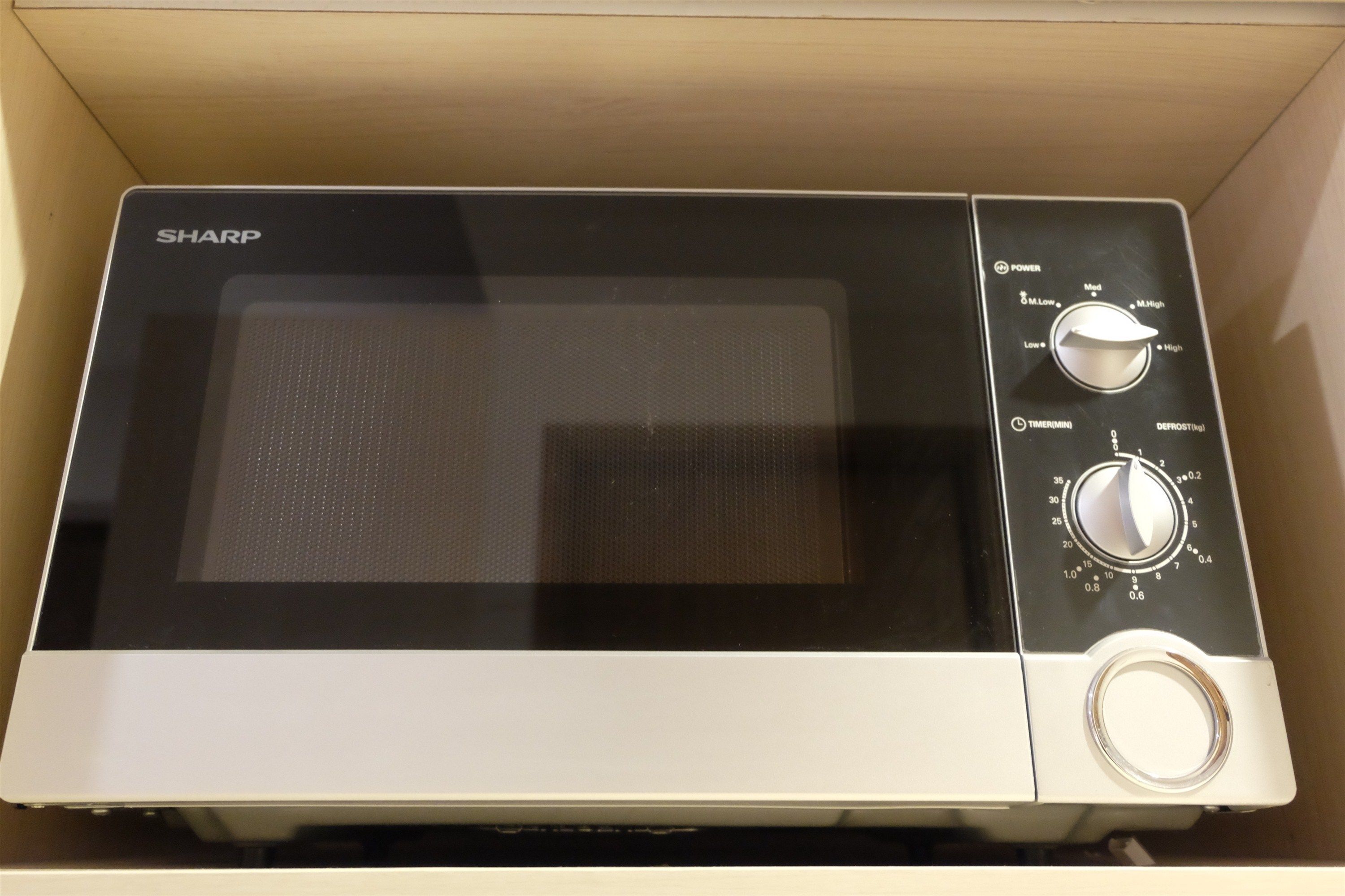 A microwave with a digital display, power settings, and a timer.