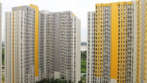A high-rise residential building with multiple balconies and a uniform facade. - Furnished Studio Apartment @ The Springlake Summarecon (Bekasi)