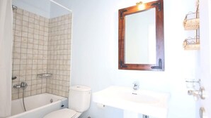 Un baño con bañera, inodoro y lavabo.
