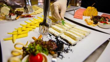 A food display with various items including cheese, fries, and vegetables.