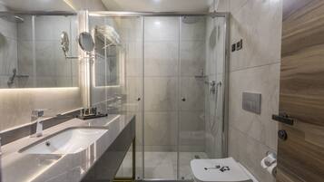 Un bagno moderno con doccia vetrata, mobile lavabo e WC.