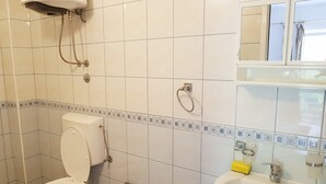 A bathroom with a toilet, a sink, and a shower.