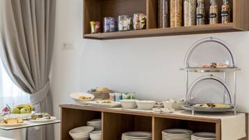 A buffet setup with various food items and condiments on shelves and a glass display case.