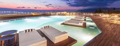 Seasonal outdoor pool, pool umbrellas, pool loungers. Messinian Icon