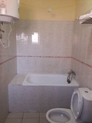 Economy Room, 1 Double Bed | Bathroom | Shower, rainfall showerhead, free toiletries, slippers