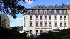 A large, multi-story hotel with a classic European architectural style, featuring a symmetrical facade and multiple windows. - Hotel Goldene Sonne (Annaberg-Buchholz)