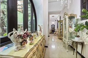 A room with ornate furniture, including a large mirror and a decorative table with figurines. - Casa Of Essence (San Juan)