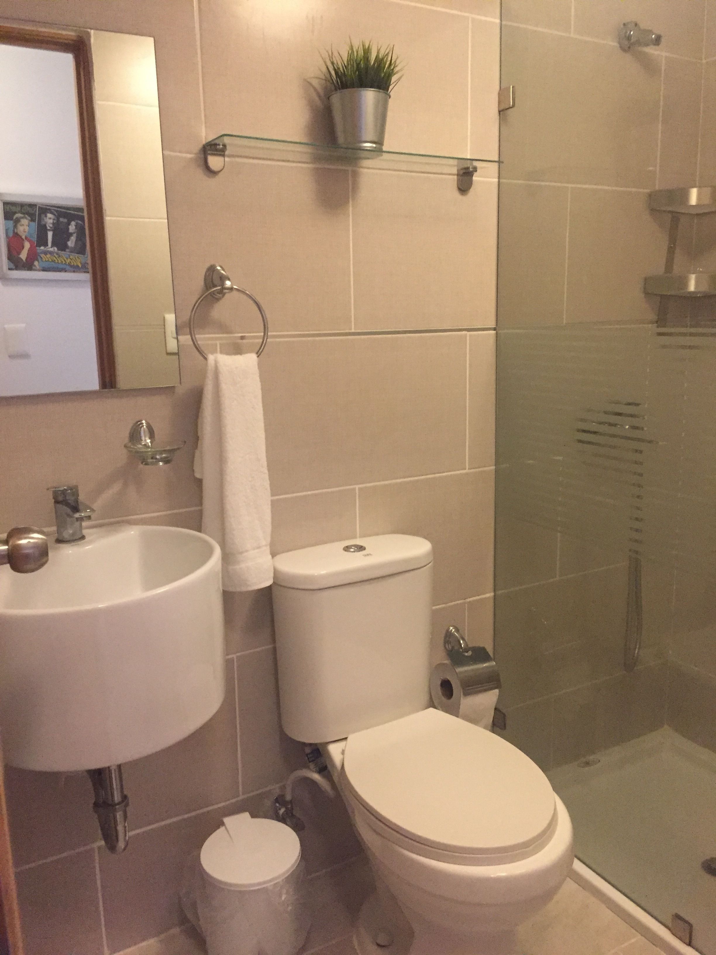 A bathroom with a sink, toilet, and shower.