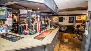A bar area with multiple taps, a pool table, and bar stools. - The Saxon Inn (Bishop Auckland)