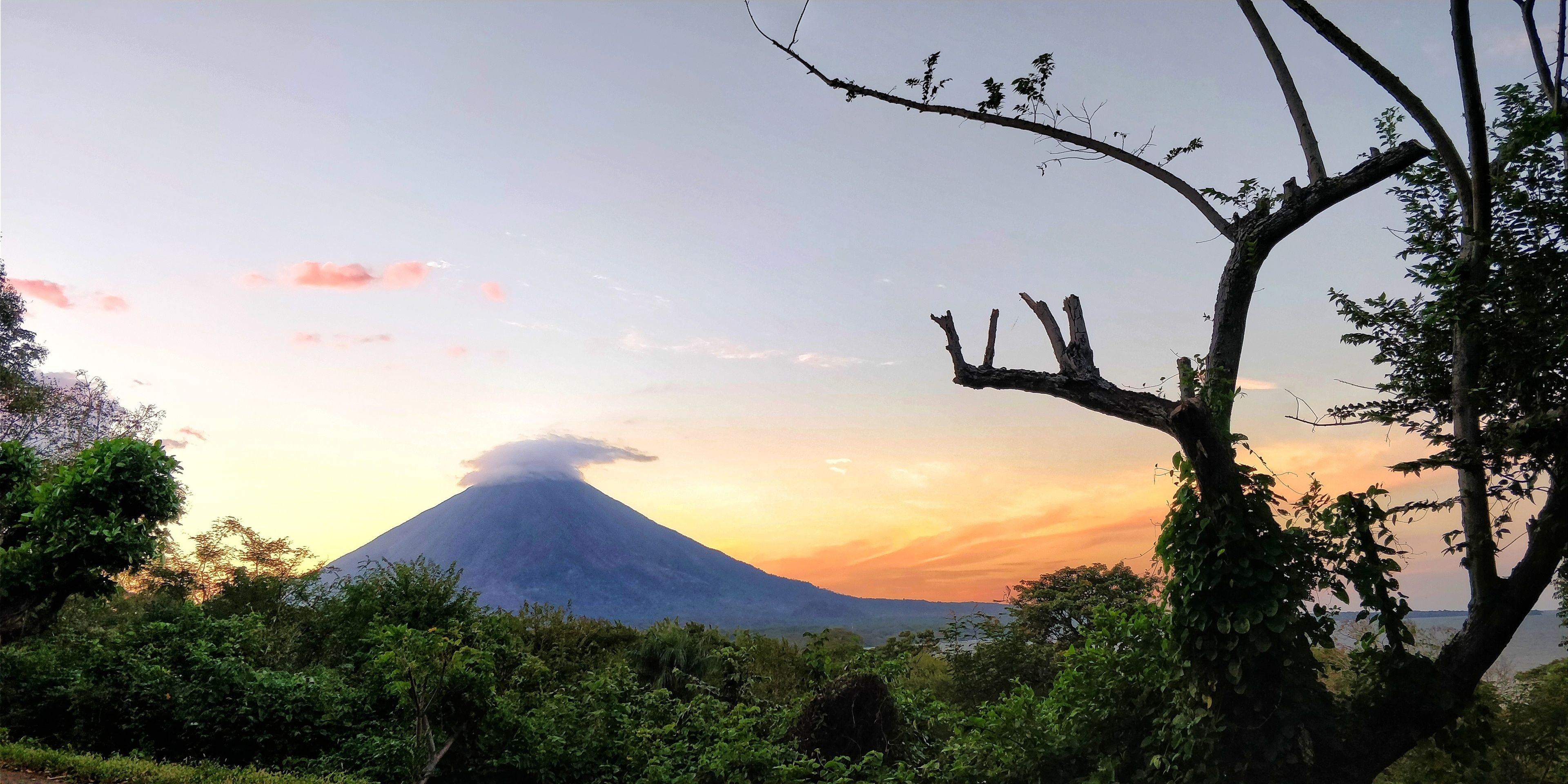 A mountain with a clear sky and a sunset.