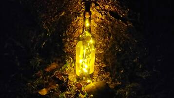 A bottle-shaped light fixture in a dark setting.