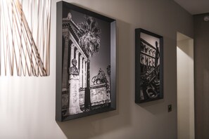 Two framed black and white photographs on a wall.