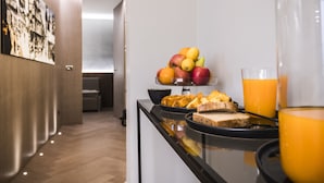 A breakfast buffet with fruits, bread, and orange juice. - inCanto (Palermo)