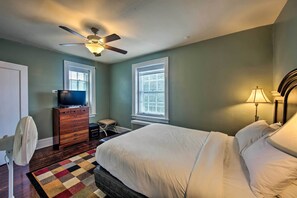 A bedroom with a bed, dresser, television, ceiling fan, windows, and a lamp. - Walk to Shops, Dining & City Park: Reading Apt (Reading)