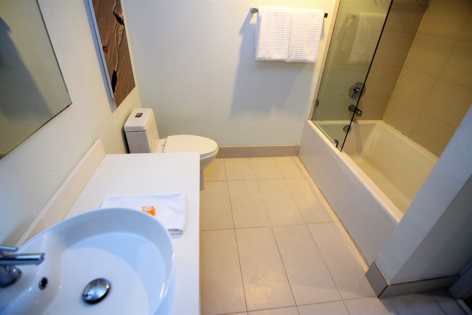 A bathroom with a sink, toilet, and bathtub.