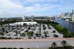 A Walmart store with a parking lot, surrounded by greenery and a river. - Ocean & Bay View Residence 1 Bed 1 Bath @ Beachwalk Hallandale Beach (Hallandale Beach)