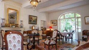 Una habitación tradicional con chimenea, muebles ornamentados y un espejo grande.