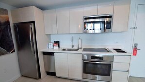 A modern kitchen with stainless steel appliances, a dishwasher, and a microwave.