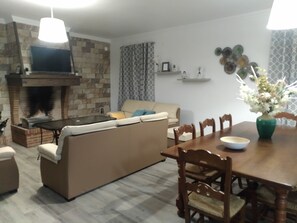 Cozy living space with a fireplace, flat-screen TV, and comfortable sofa.