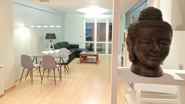 A modern living room with a dining area, a black sofa, and a glass table. - Apartment towers, wifi, pool, breakfast. (Calahorra)