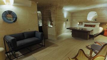 A modern interior with a sofa, a bed, a dining table, and a chair.