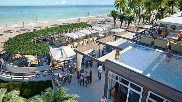 A rooftop pool area with lounge seating and a view of the beach. - Ocean View 3 Bed 3 Bath Across The Beach @ Beachwalk (Hallandale Beach)