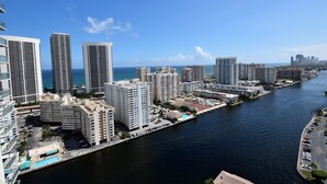 A high-rise hotel with multiple floors, a marina, and a view of the ocean. - Ocean & Bay View Residence 1 Bed 1 Bath @ Beachwalk (Hallandale Beach)