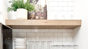 A kitchen with white tiled backsplash, wooden shelves, and a hanging light fixture. - 🐄The Farm House 🐄 POOL IS OPEN!!! (Washington)