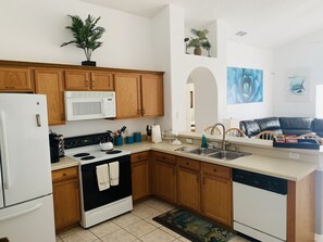 Enjoy cooking in this fully equipped kitchen with a stove, microwave, and dishwasher.