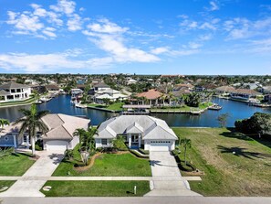 A residential area with houses, a marina, and a lake. - Luxuriously Furnished Waterfront Home With Pool/spa (Marco Island)