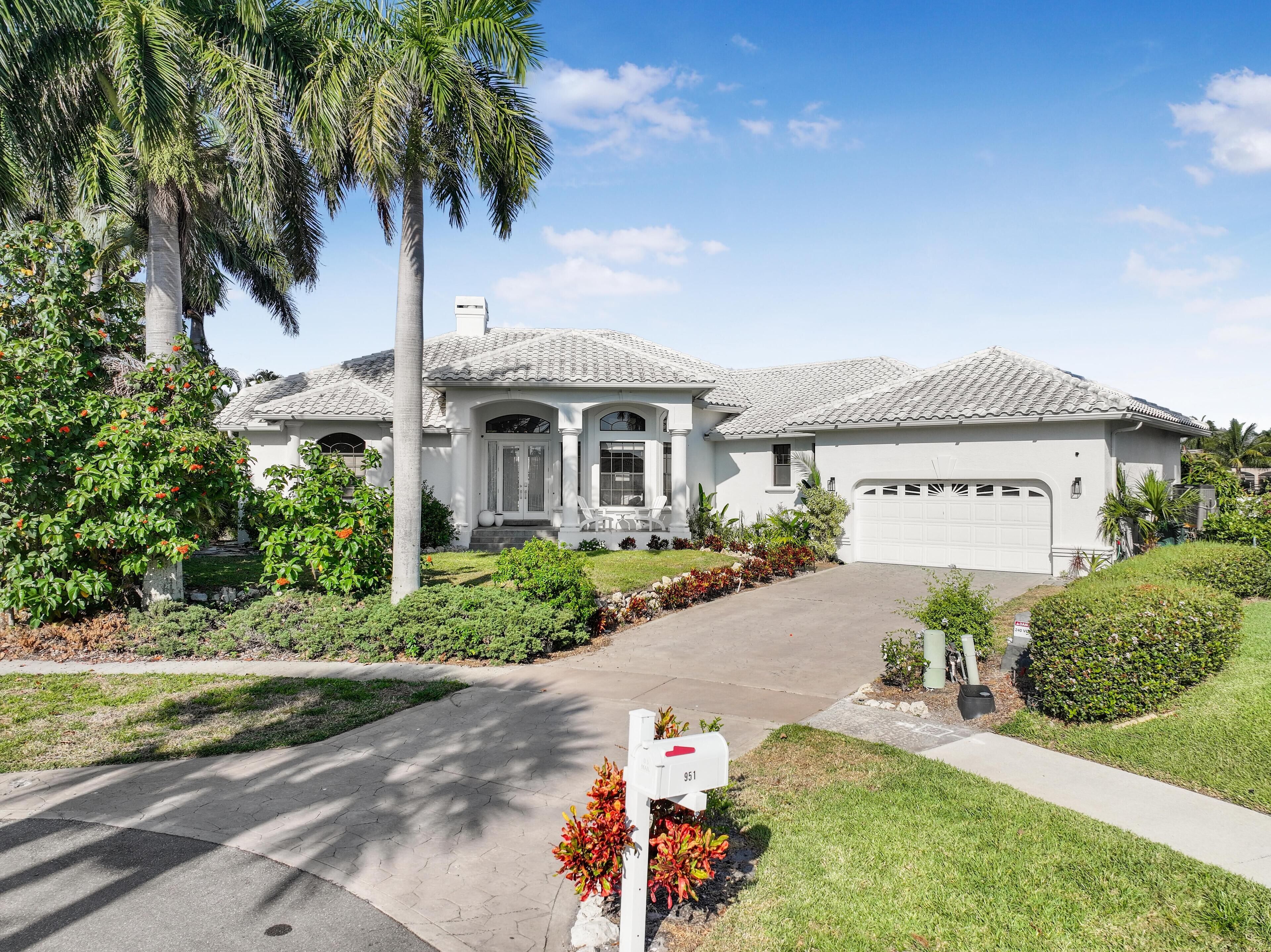 A single-story house with a tiled roof, a front porch, and a garage.