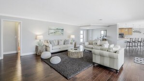 A modern living room with a sofa set, a coffee table, and a rug. - 216 Shadowridge Court (Marco Island)