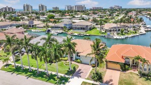 A residential area with houses, a marina, and a body of water.