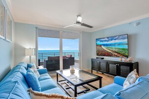 Condo, Multiple Beds (Beachfront condo with 180-degree view) | Living room | Flat-screen TV
