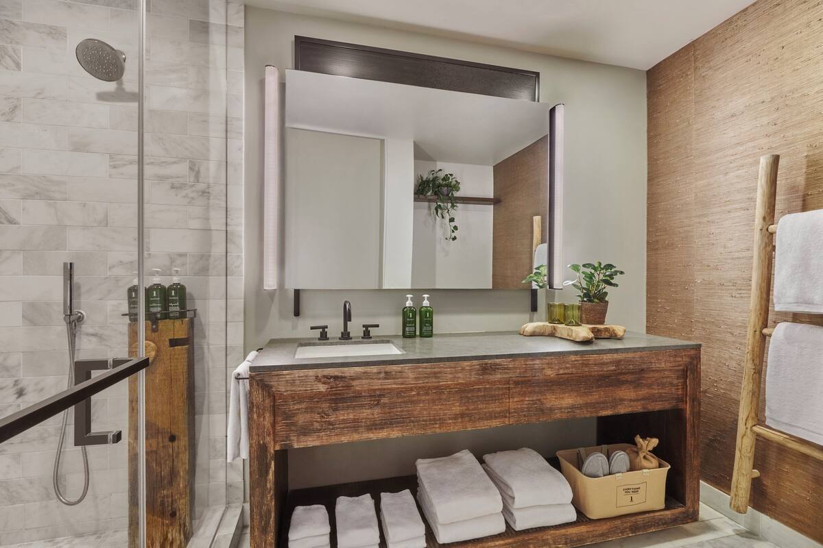 deep-soaking bathtub, designer toiletries, hair dryer, bathrobes