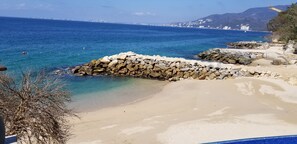 Enjoy the serene beach and city views from this scenic coastal spot.