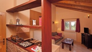 A cozy living room with a fireplace, a sofa, a coffee table, and a window with curtains. - Klara in Poreč - Istrien / Klara in Poreč - Appartement für 2 Personen AP2 (Porec)