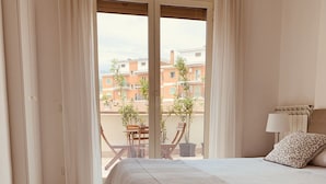 A bedroom with a large bed, a view of the outside balcony, and a window with curtains. - NEW BEAUTIFUL APARTMENT WITH LARGE TERRACE- A CASA DI CAROLINA (Cassino)