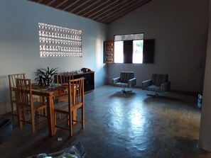 Relax in this inviting living area with a dining table, comfortable seating, and a beautiful view.
