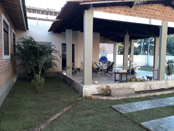 Relax in a serene outdoor space with a patio, seating area, and lush greenery.
