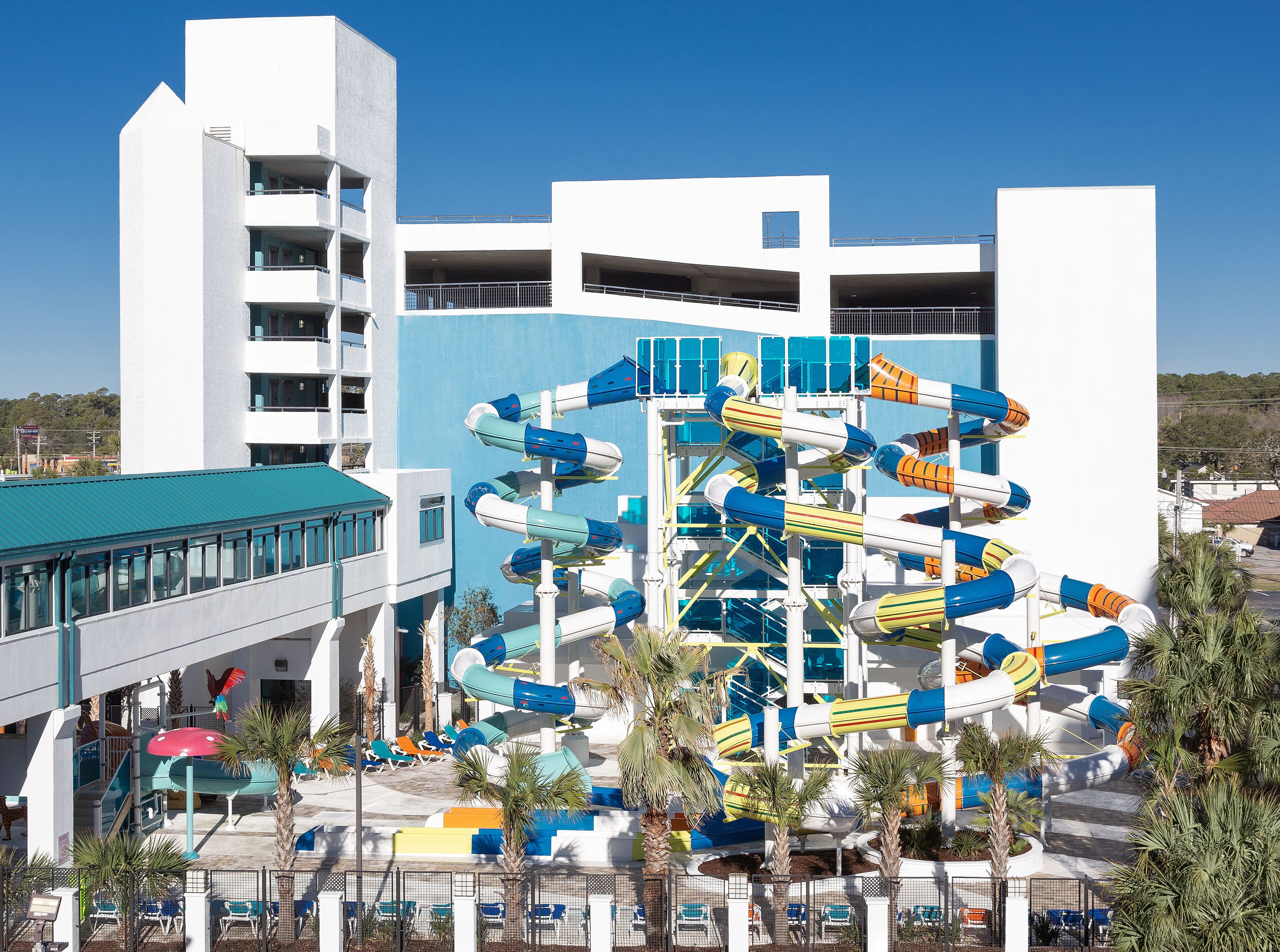 A water park with multiple slides and a building with balconies.